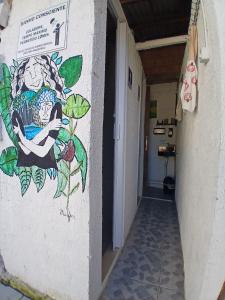 a painting on the side of a wall in a hallway at Cabanas LA CASITA BRISA DO MAR in Navegantes