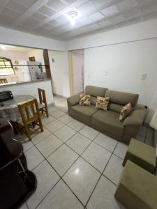 a living room with a couch and a table at Recanto do major in Petrópolis
