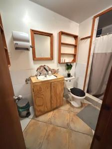a bathroom with a sink and a toilet at Hostal ídem in Valparaíso