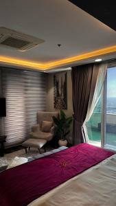 a bedroom with a bed and a couch and a window at Goldcrest Alfatah Mall - DHA Phase 4 - Luxury Apartments by Alvis Suite in Lahore