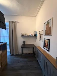 a living room with a table and a television at Home From Home in Liverpool