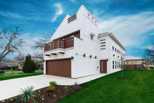 a white house with a garage in a yard at Game Room & Event Open Luxury Haven in Dallas