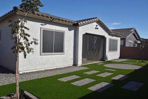 a house with a green lawn in front of it at BnB Vacation Home in Queen Creek