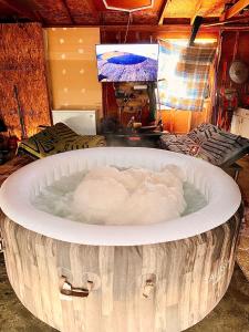 a large tub filled with water in a room at Cozy RV Farm Stay with Hot Tub WiFi and Coffee 5 Min to AHCL Hospital and Redbud Park in Clearlake