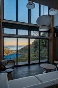a living room with large windows and a view of the ocean at Amao Villa 自然郷 in Atami