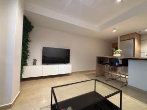 a living room with a flat screen tv on a wall at Cosy Flat Valencia in Masanasa