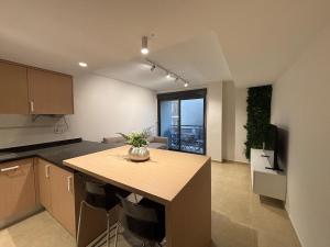 a kitchen with a island in the middle of a room at Cosy Flat Valencia in Masanasa