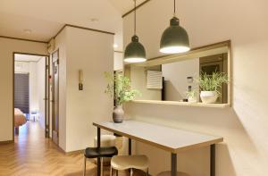 a kitchen with a table and chairs and a mirror at Valley 3F - Mid Century Modern Kawaramachi Apt in Takamatsu