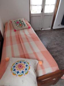 a bed in a room with two pillows on it at Benito Soria 137 in Santa Rosa de Calamuchita