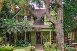 a green house with a tree in front of it at Alpine Haven at Alpine Villas by Crosswinds Tagaytay & Free Parking in Sampong