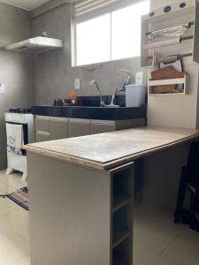 a kitchen with a counter top and a sink at NoiZ Apartment - SofaHouse in Rio das Ostras +10 photos