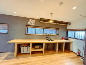 a kitchen with a wooden counter top in a room at 雲の家 旧東海道沿いの畑宿の温もりステイ in Hakone +13 photos
