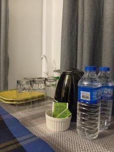 a table with two bottles of water and a blender at The Kandy Look Homestay in Kandy +10 photos