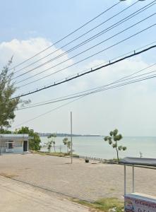 a view of the ocean from a parking lot at Villa Hayoo ayem in Sukowati +3 photos