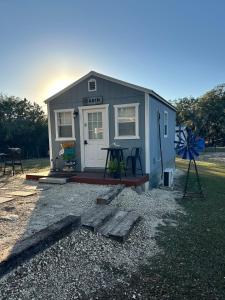 a tiny house sitting on top of a pile of gravel at Tiny house - Our little piece of paradise in Lakehills