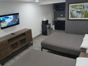 a bedroom with a bed and a flat screen tv at Rodeway Inn in Livingston