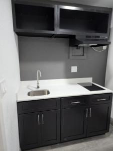 a kitchen with a sink and a counter top at Rodeway Inn in Livingston +47 photos