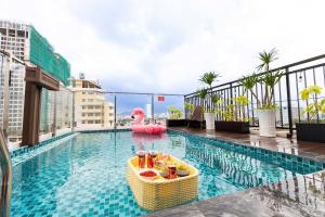 a swimming pool with a pool noodle in the middle of a building at Euro Star Riverside Hotel in Danang