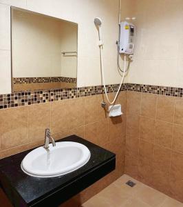 a bathroom with a sink and a mirror at The Nap House Phuket Town in Phuket Town