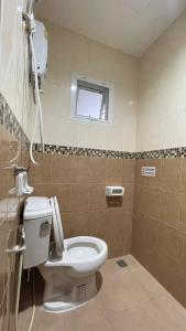 a bathroom with a toilet and a window at The Nap House Phuket Town in Phuket +6 photos