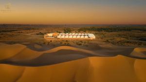 an aerial view of a building on an island in the water at Jaisan Heritage Desert Camp in Jaisalmer