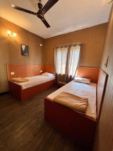 a bedroom with two beds and a ceiling at Spacious 3BHK Family Home in Bengaluru