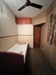 a room with a bed and a ceiling fan at Spacious 3BHK Family Home in Bengaluru