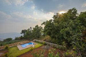an aerial view of a villa with a swimming pool and trees at Lifeline Villas -Sunset Bird Infinity Pool Villa With Valley View in Panchgani +13 photos