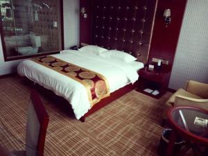 Postel nebo postele na pokoji v ubytování Xinlu Hotel