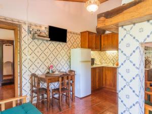 a kitchen with a table and a refrigerator at Wine Country Home in Alentejo in Montemor-o-Novo