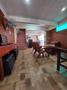 a large living room with a table and chairs at TaKaYai GuestHouse in Cha Am