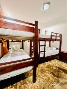 a bedroom with three bunk beds in a room at Casa Don 20 in San Marcos La Laguna