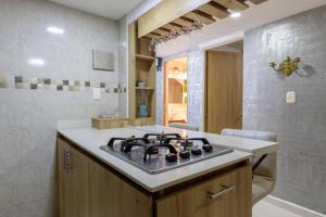 a kitchen with a stove top in a room at Apartamento con Jacuzzi privado Cerca al Metro y al Mayorca in Envigado +44 photos