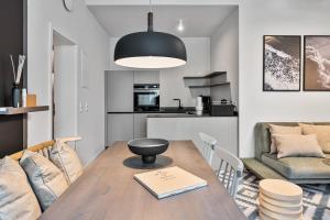 a kitchen and living room with a table and a couch at Alte Schule Westerhever Poppenbüll in Westerhever