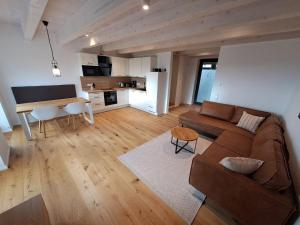 a living room with a couch and a table at Gulfhof Wangermeer 2 Tilda in Hohenkirchen