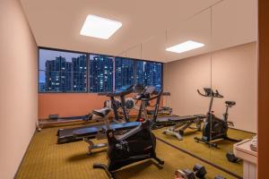 une salle de sport avec vue sur les toits de la ville dans l'établissement Kouring Ruiyue Hotel Guogongzhuang Subway Station Branch, à Pékin