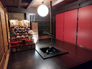 - une cuisine avec des placards rouges et un évier dans la chambre dans l'établissement さぬきの宿 古民家 岡本, à Oda