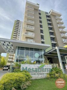 een groot gebouw met een bord ervoor bij Urban Haven Davao in Davao City