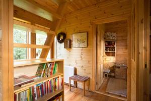 a room with a book shelf in a wooden cabin at Beautiful Cottage in Hveragerdi in Hveragerði