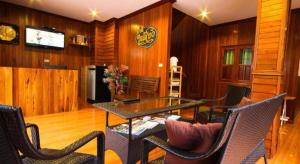 ein Zimmer mit Tisch und Stühlen und einem Fernseher in der Unterkunft Ban Glai Kong in Chiang Khan + 15 Fotos