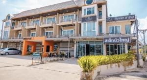 a large building with a sign in front of it at Crystal Place Buayai in Bua Yai