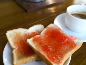two pieces of bread with jam on a plate with a cup of coffee at SabayNan Hotel in Ban Nong Tao +50 photos