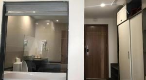 a bathroom with a tub and a sink and a mirror at Smart Hotel in Bắc Ninh +55 photos