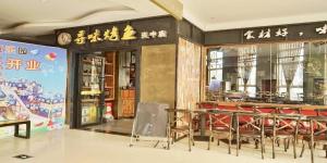 a restaurant with tables and chairs in a building at Xana Lite Neijiang Zizhong Shanghehui Branch in Shuinan