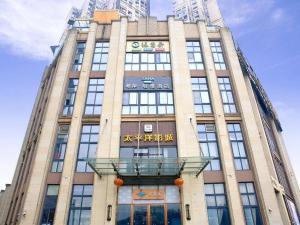 a tall building with a sign on the front of it at Xana Lite Neijiang Zizhong Shanghehui Branch in Shuinan