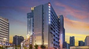 a tall building with a sign on the side of it at SOFIS POP HOTEL in Fuzhou