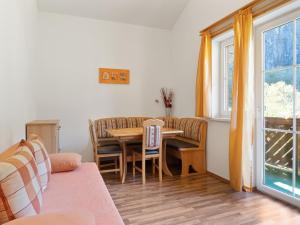 a living room with a table and chairs and a window at Apartment in Grossarl near Ski Slopes in Grossarl