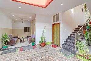 a living room with a staircase in a house at HOTEL O LAXMAN GRAND in Tapovan