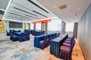 a conference room with blue tables and purple chairs at Echarm Hotel Wuhan High-speed Rail Peace Park Metro Station in Wuhan