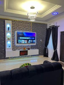 a living room with a flat screen tv on a wall at Fm homes in Lekki